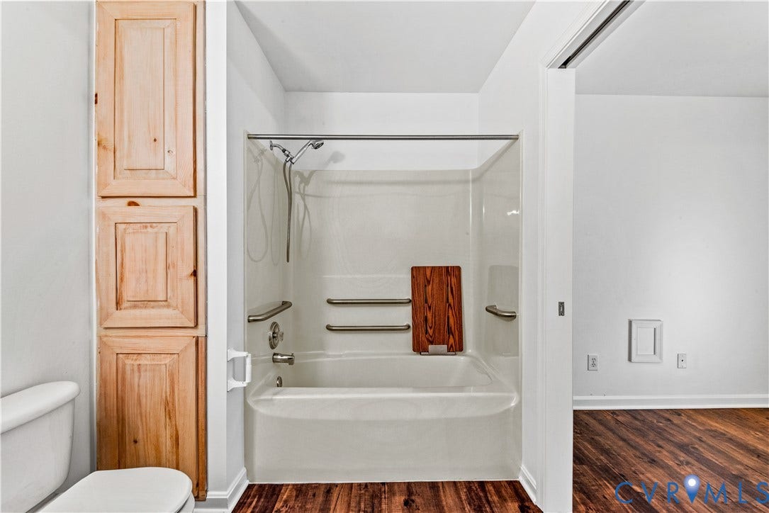20040 Paradise Lane, Ruther Glen, VA 22546 Full-height natural wood cabinetry, shower and tub combination with metallic grab bars, and wood-finish flooring