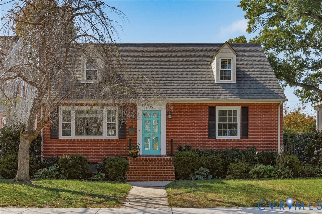 5028 Devonshire Road, Richmond, VA 23225 Brick exterior featuring dual dormer windows, shutter-framed windows, and an arched entryway with a paneled door