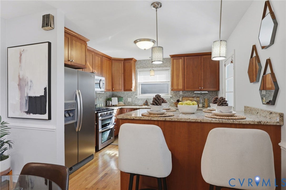 5028 Devonshire Road, Richmond, VA 23225 Kitchen featuring natural wood cabinetry, stone countertops, stainless steel appliances, wood-finish flooring, and dual hanging pendant lights