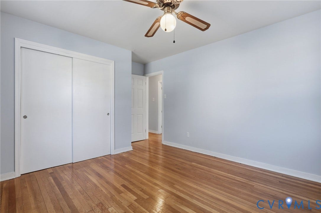 5028 Devonshire Road, Richmond, VA 23225 Room featuring wood-finish flooring, sliding-door closet, and ceiling fan with integrated light fixture