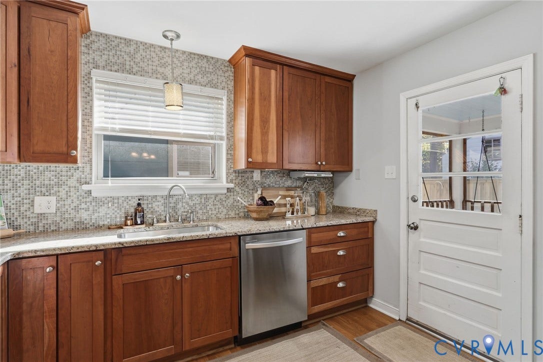 5028 Devonshire Road, Richmond, VA 23225 Kitchen featuring stained wood cabinetry, stone-finish countertops, mosaic tile backsplash, stainless steel dishwasher, and a glass-paneled exterior door