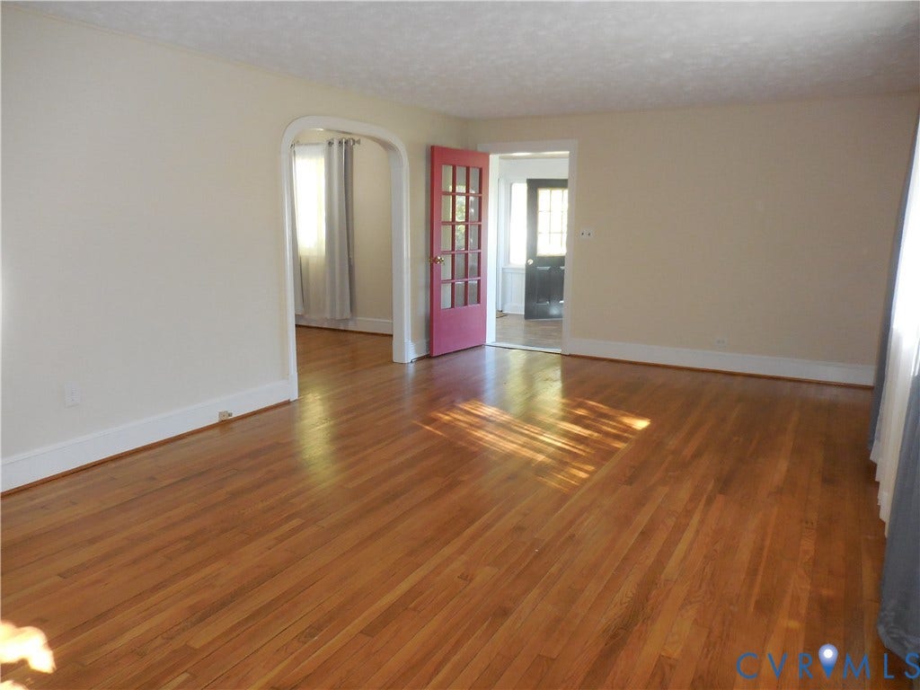25 Bethany Church Road, Bumpass, VA 23024 Interior space featuring wood-finish flooring, an arched entryway, and a multi-pane glass door