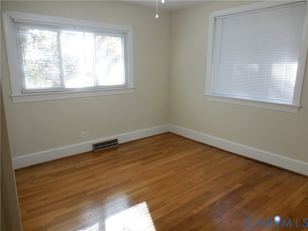 25 Bethany Church Road, Bumpass, VA 23024 Wood-finish flooring, neutral wall tones, and dual windows with horizontal blinds