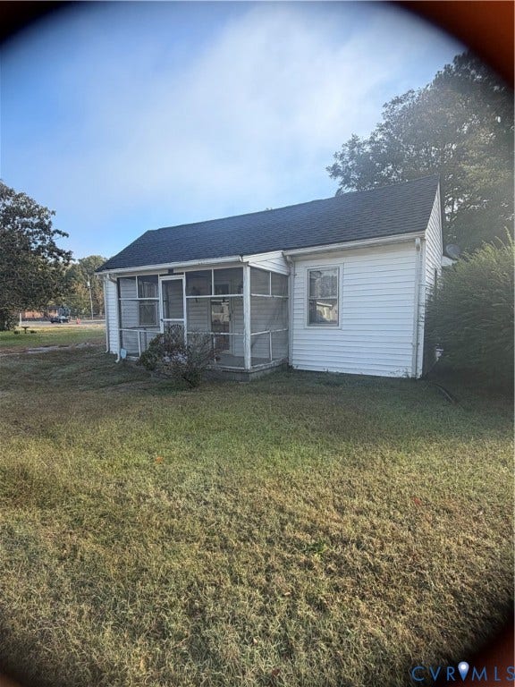 115 Elm Street, Waverly, VA 23890 Single-story home featuring white horizontal siding, a screened front porch, and a gable roof with asphalt shingles
