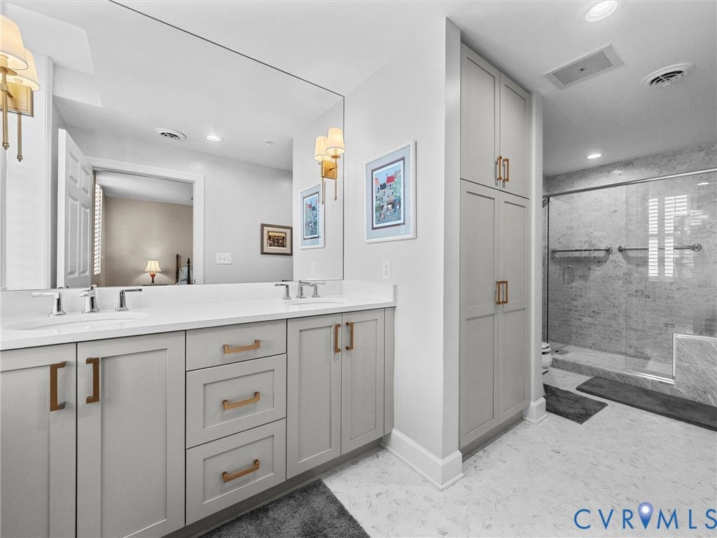 413 Stuart Circle, #3B, Historic Fan District, Richmond, VA 23220 Primary bath with double vanity, built-in linen closet and large walk-in marble shower.