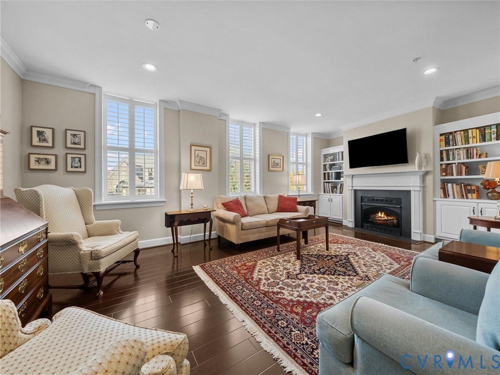 413 Stuart Circle, #3B, Historic Fan District, Richmond, VA 23220 Living room has crown moulding and plantation shutters.