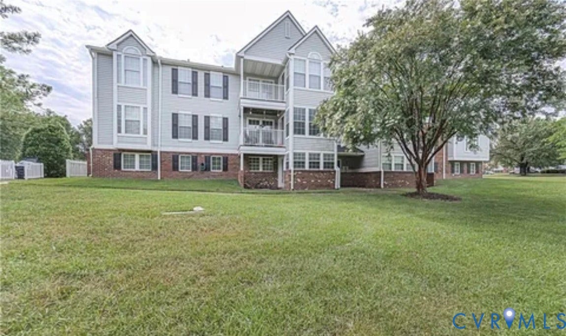 10211 Wolfe Manor Court, #711, Glen Allen, VA 23060 Multi-story exterior featuring a brick and siding facade, stacked private balconies, and double-hung windows with decorative shutters