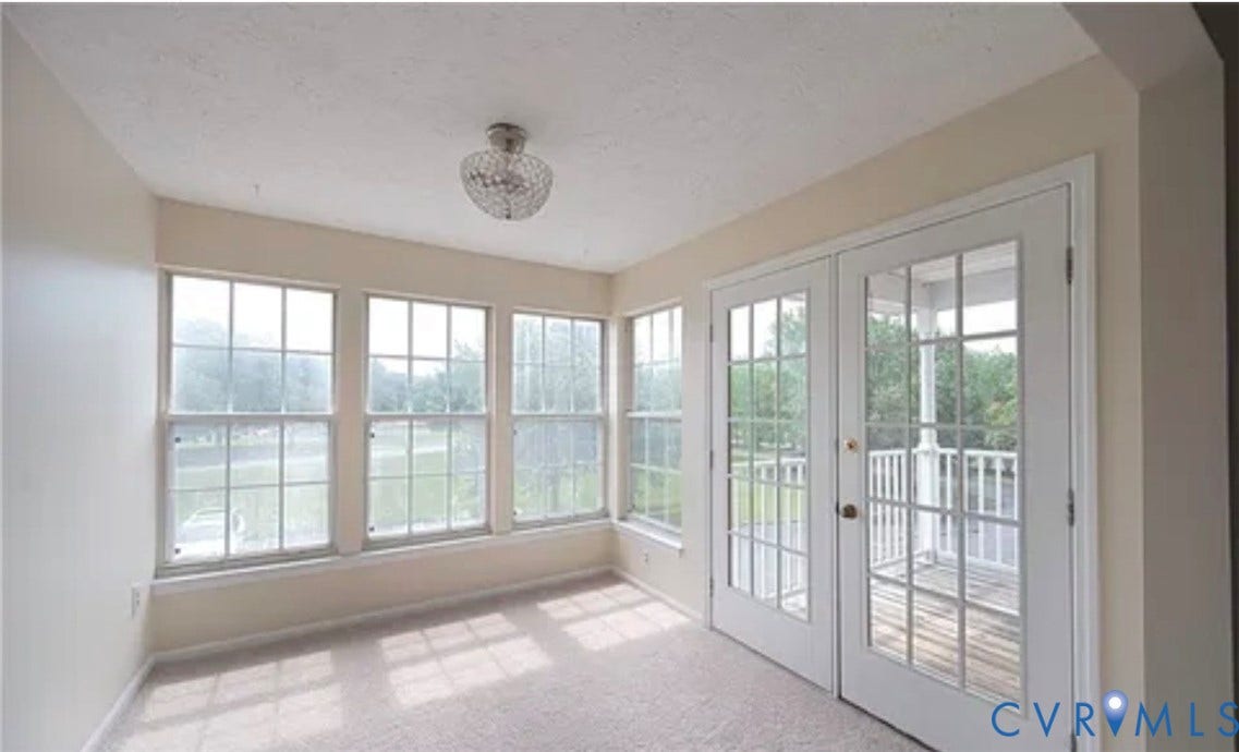 10211 Wolfe Manor Court, #711, Glen Allen, VA 23060 Interior space featuring multi-pane windows, double glass-panel doors with exterior access, neutral carpeting, and a polished metal globe-style ceiling fixture