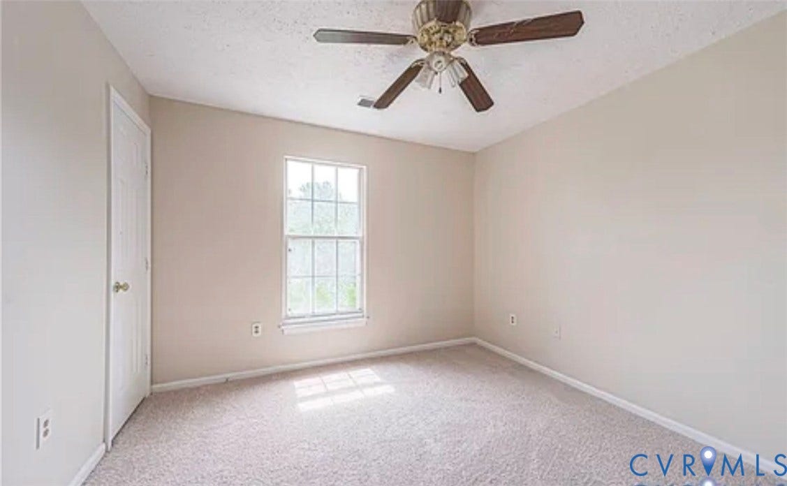 10211 Wolfe Manor Court, #711, Glen Allen, VA 23060 Neutral-toned interior room featuring wall-to-wall carpeting, a multi-pane window, and a ceiling fan with integrated lighting