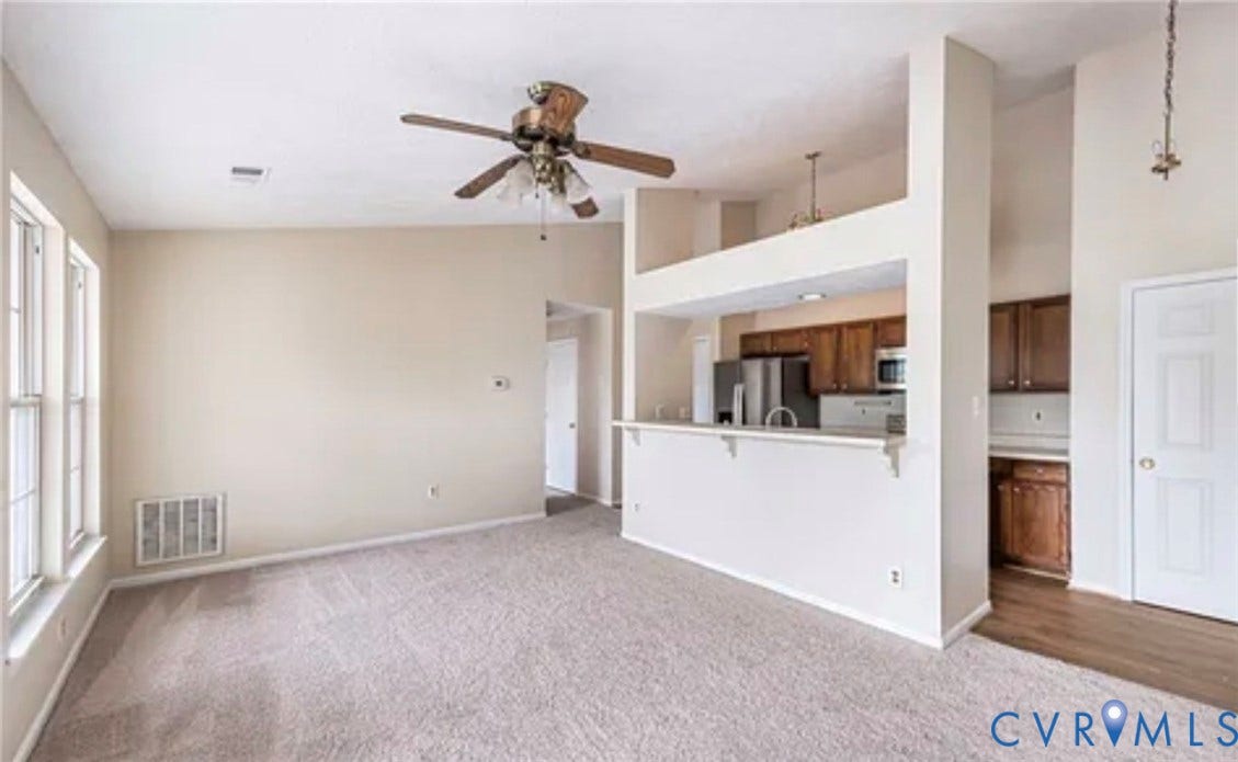 10211 Wolfe Manor Court, #711, Glen Allen, VA 23060 Vaulted ceilings featuring a ceiling fan, pass-through kitchen breakfast bar, wood-finish cabinetry, and neutral carpeting
