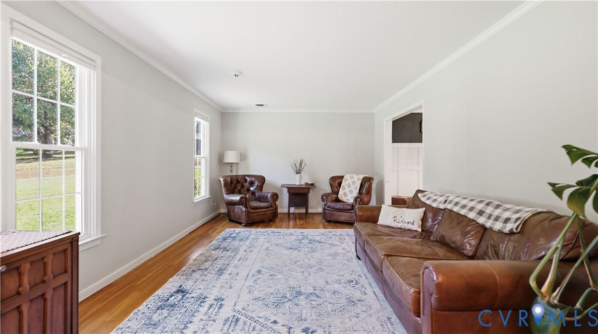 10010 Cheyenne Court, Richmond, VA 23235 Living area featuring light-toned neutral walls, multiple multi-pane windows, and polished wood-finish flooring