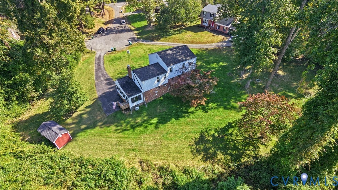 10010 Cheyenne Court, Richmond, VA 23235 Multi-level residence featuring brick and siding exterior, paved driveway, detached storage structure, and expansive lot with mature trees