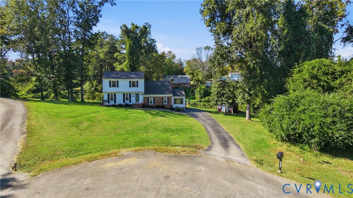 10010 Cheyenne Court, Richmond, VA 23235 Two-story residence featuring a brick and siding exterior, expansive lawn, mature perimeter trees, and an asphalt driveway