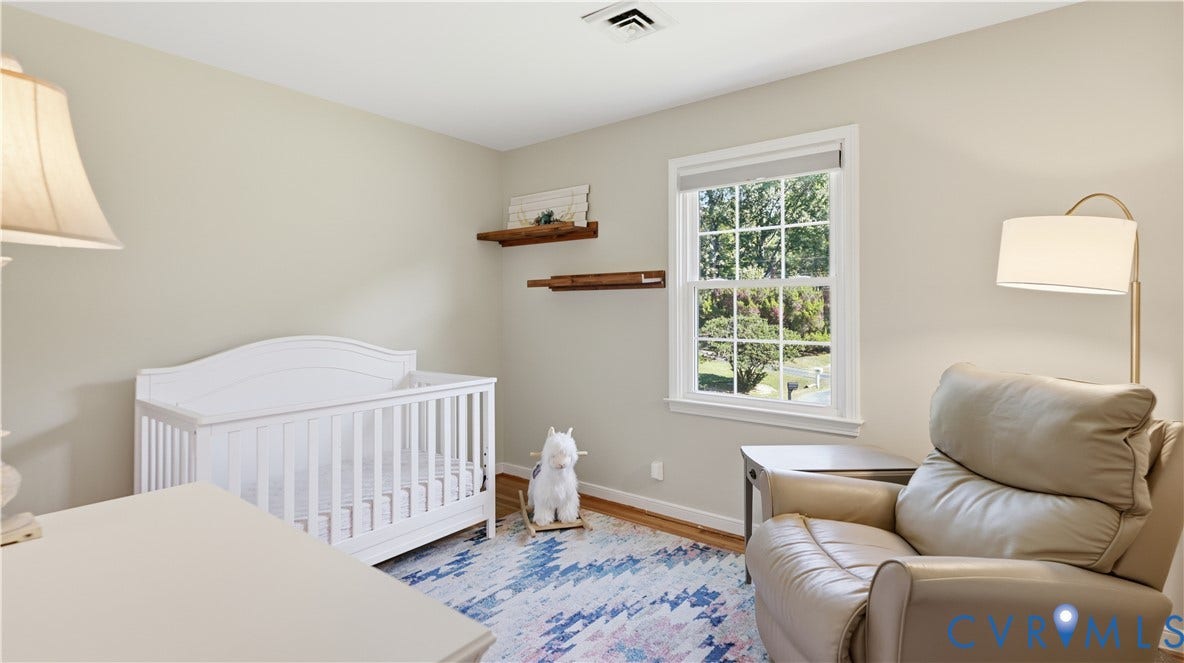 10010 Cheyenne Court, Richmond, VA 23235 Neutral wall tones, wood-finish flooring, multi-pane window, and dual floating wood wall shelves