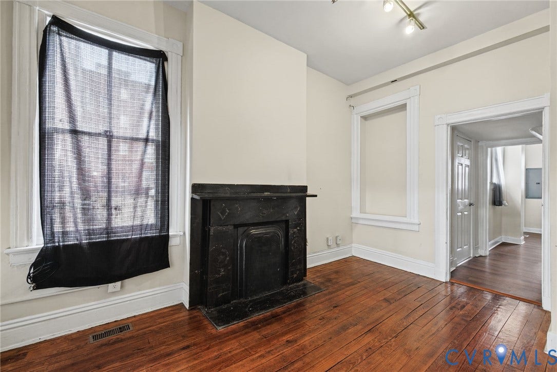 510 N 3rd Street, Jackson Ward, Richmond, VA 23219 Wood-finish flooring, black hearth fireplace with mantle, and white window casing