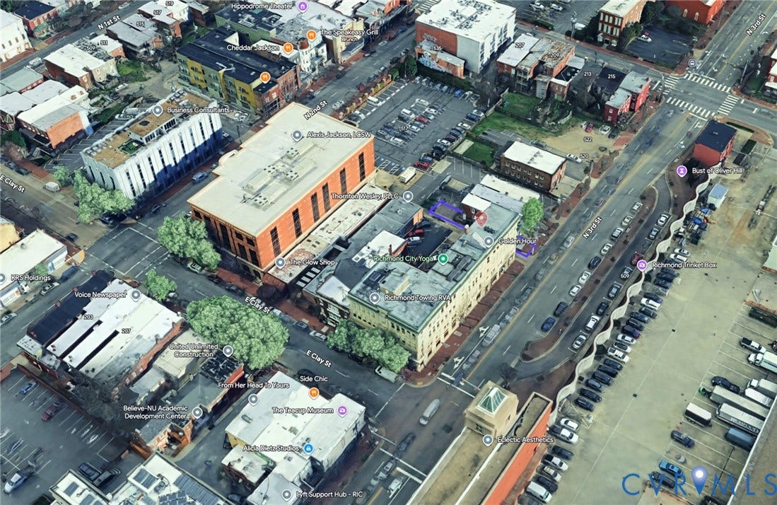 510 N 3rd Street, Jackson Ward, Richmond, VA 23219 Aerial perspective of a multi-story urban building situated in a dense commercial corridor with direct street frontage and rooftop access