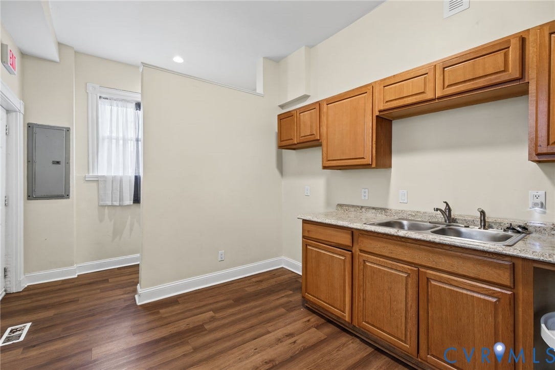 510 N 3rd Street, Jackson Ward, Richmond, VA 23219 Wood-finish flooring, light-toned cabinetry, stone-finish countertops, and a dual-basin stainless steel sink
