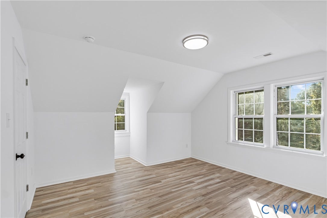 19614 Manson Church Road, Mc Kenney, VA 23872 Interior space featuring neutral wall paint, wood-finish flooring, multi-pane windows, and a flush-mount circular light fixture