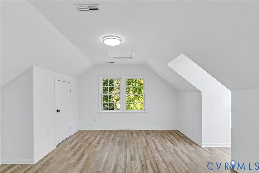 19614 Manson Church Road, Mc Kenney, VA 23872 Interior space featuring wood-finish flooring, vaulted ceilings with dual-pane windows, and integrated flush-mount lighting