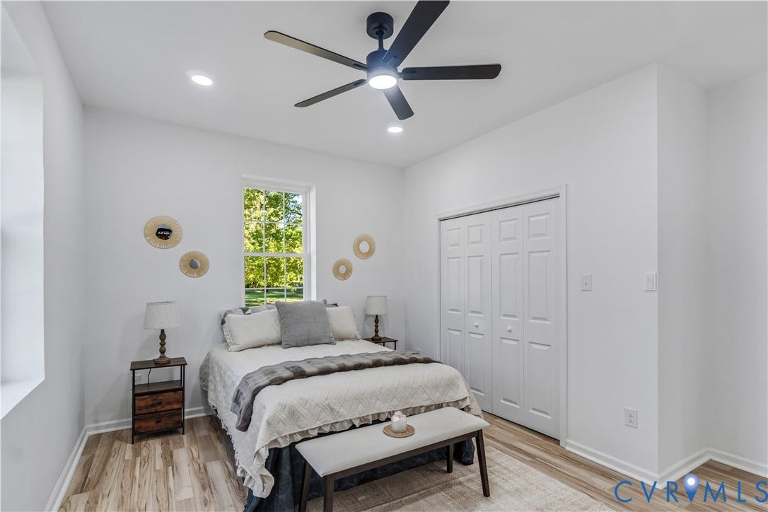 19614 Manson Church Road, Mc Kenney, VA 23872 Neutral-toned interior featuring wood-finish flooring, a matte black multi-blade ceiling fan with integrated lighting, recessed lighting, and a dual-panel closet door