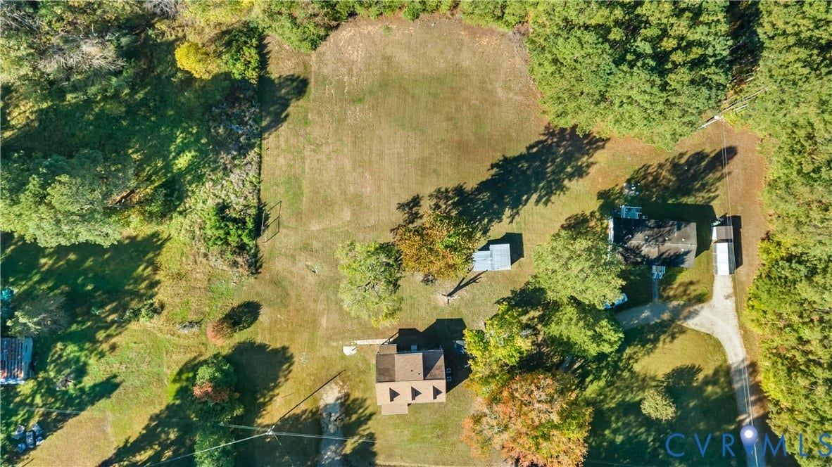19614 Manson Church Road, Mc Kenney, VA 23872 Expansive parcel featuring mature trees, open clearing, gravel driveway, and multiple structural improvements
