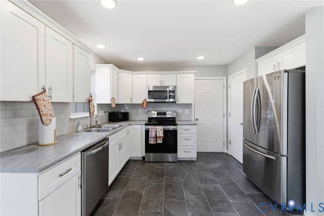 6614 Gills Gate Drive, Chesterfield, VA 23832 Kitchen featuring white cabinetry, grey stone-finish countertops, stainless steel appliances, a light-toned tile backsplash, and dark tile flooring