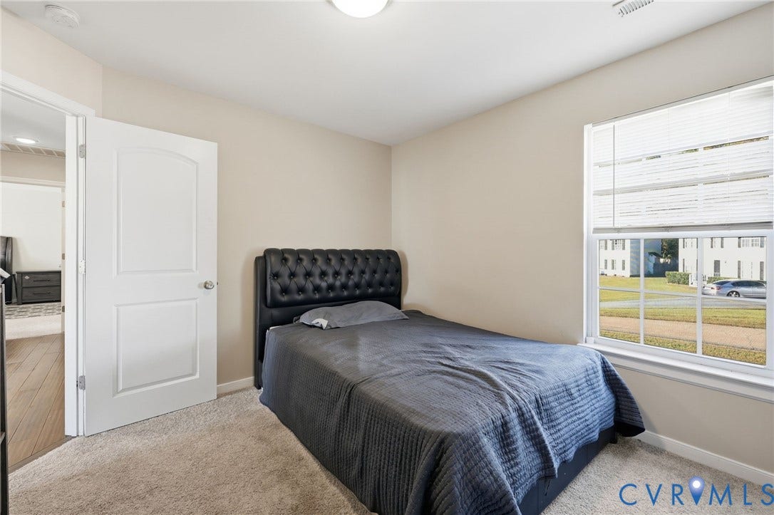 6614 Gills Gate Drive, Chesterfield, VA 23832 Neutral-toned interior featuring wall-to-wall carpeting, a multi-pane window with blinds, and a two-panel interior door
