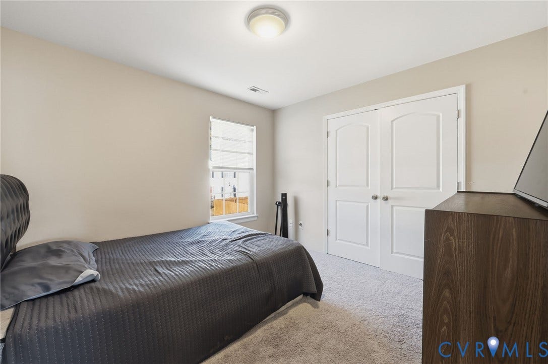 6614 Gills Gate Drive, Chesterfield, VA 23832 Neutral-toned interior featuring plush carpeting, dual-panel closet doors, single-hung window, and a flush-mount ceiling light