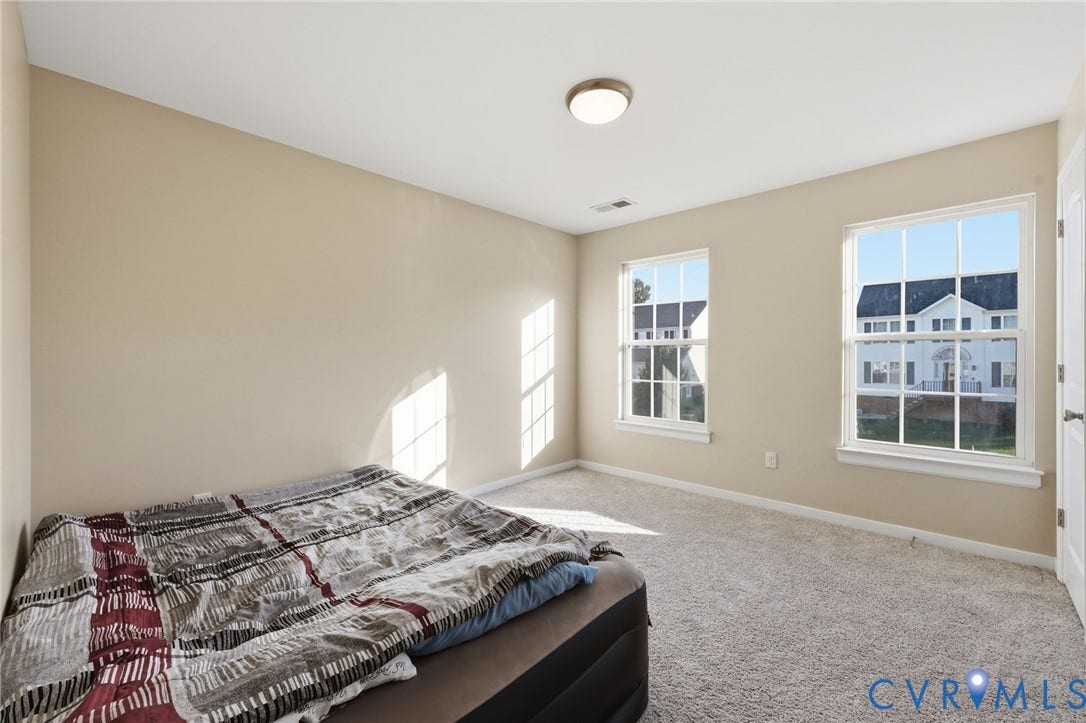 6614 Gills Gate Drive, Chesterfield, VA 23832 Interior space featuring neutral-tone walls, wall-to-wall carpeting, two double-hung windows with mullions, and a flush-mount ceiling light fixture