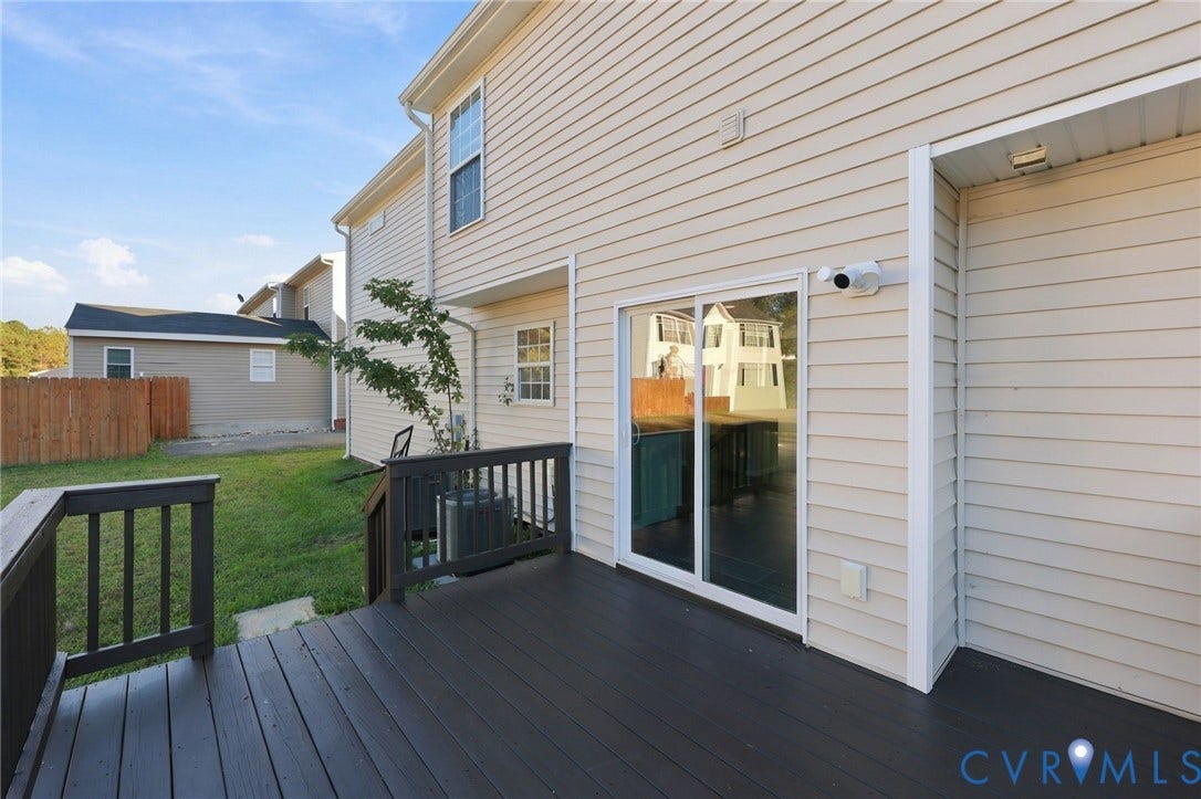 6614 Gills Gate Drive, Chesterfield, VA 23832 Exterior deck with dark-stained wood-finish flooring and railing, light-toned horizontal siding, and sliding glass door