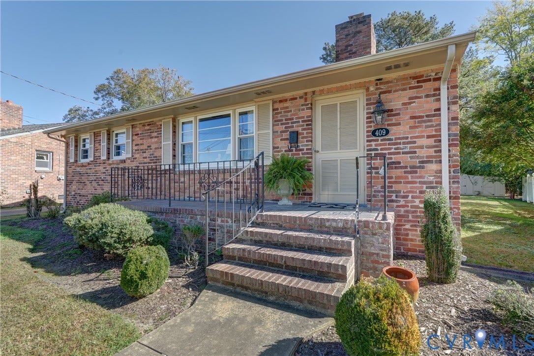 409 Lilliston Avenue, Colonial Heights, VA 23834 Brick exterior featuring a multi-pane window configuration, covered entryway, masonry chimney, and metal railings