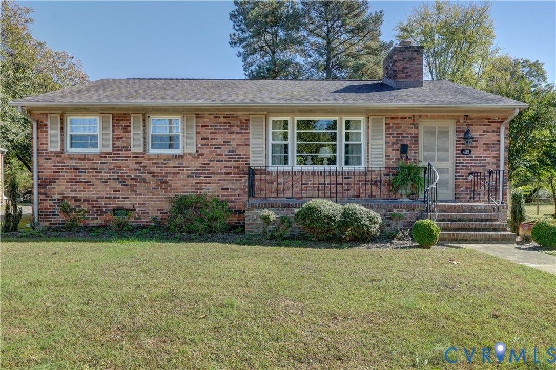409 Lilliston Avenue, Colonial Heights, VA 23834 Ranch-style residence featuring a classic brick exterior, dimensional shingle roof, chimney, front porch with wrought-iron railing, and large multi-pane windows