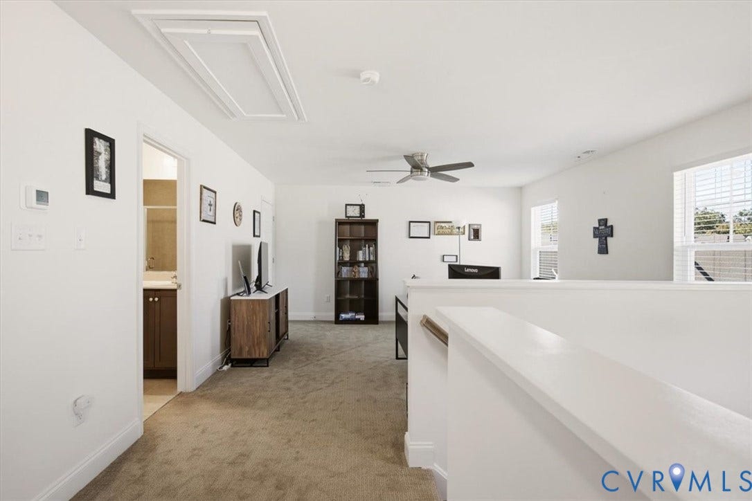 18743 Palisades Ridge, Palisades Cove, Moseley, VA 23120 Open floor area with neutral carpeting, ceiling fan, dual windows, and access to a bathroom