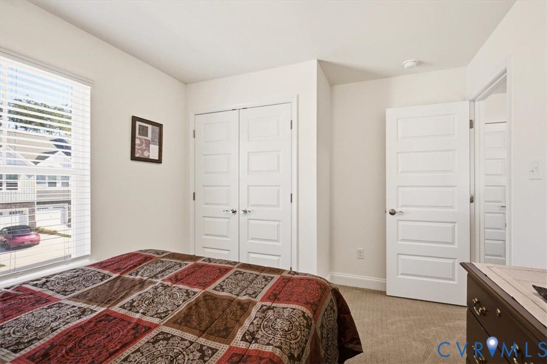 18743 Palisades Ridge, Palisades Cove, Moseley, VA 23120 Neutral-toned room featuring wall-to-wall carpeting, a multi-pane window, and two paneled interior doors, including a double-door closet