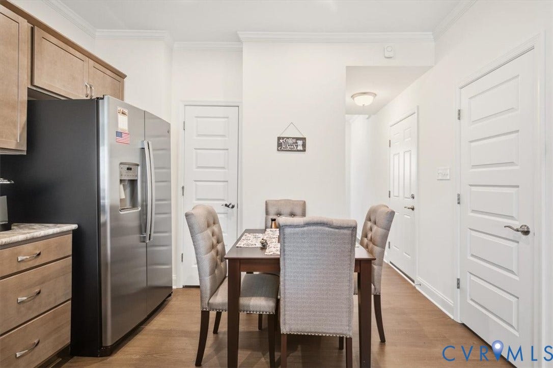 18743 Palisades Ridge, Palisades Cove, Moseley, VA 23120 Kitchen featuring wood-finish cabinetry, stainless steel side-by-side refrigerator, wood-finish flooring, and crown molding