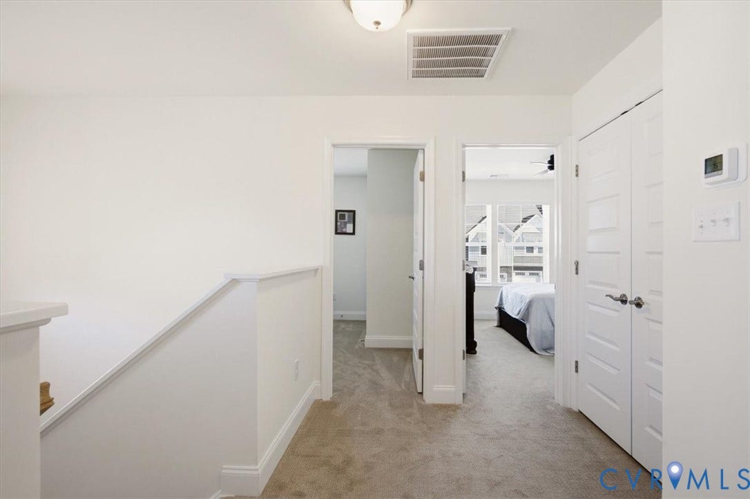 18743 Palisades Ridge, Palisades Cove, Moseley, VA 23120 Hallway featuring neutral carpet flooring, white paneled interior doors, and overhead flush-mount lighting