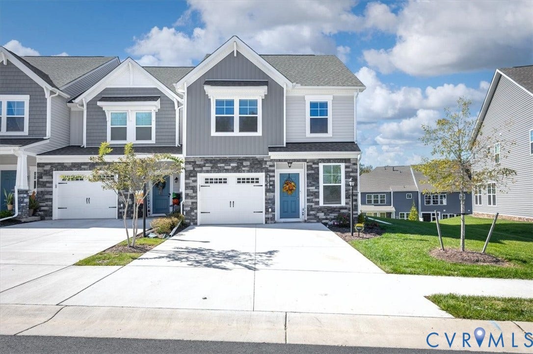 18743 Palisades Ridge, Palisades Cove, Moseley, VA 23120 Two-story exterior featuring stone veneer siding, dual-pane windows, a paved concrete driveway, and an attached two-car garage