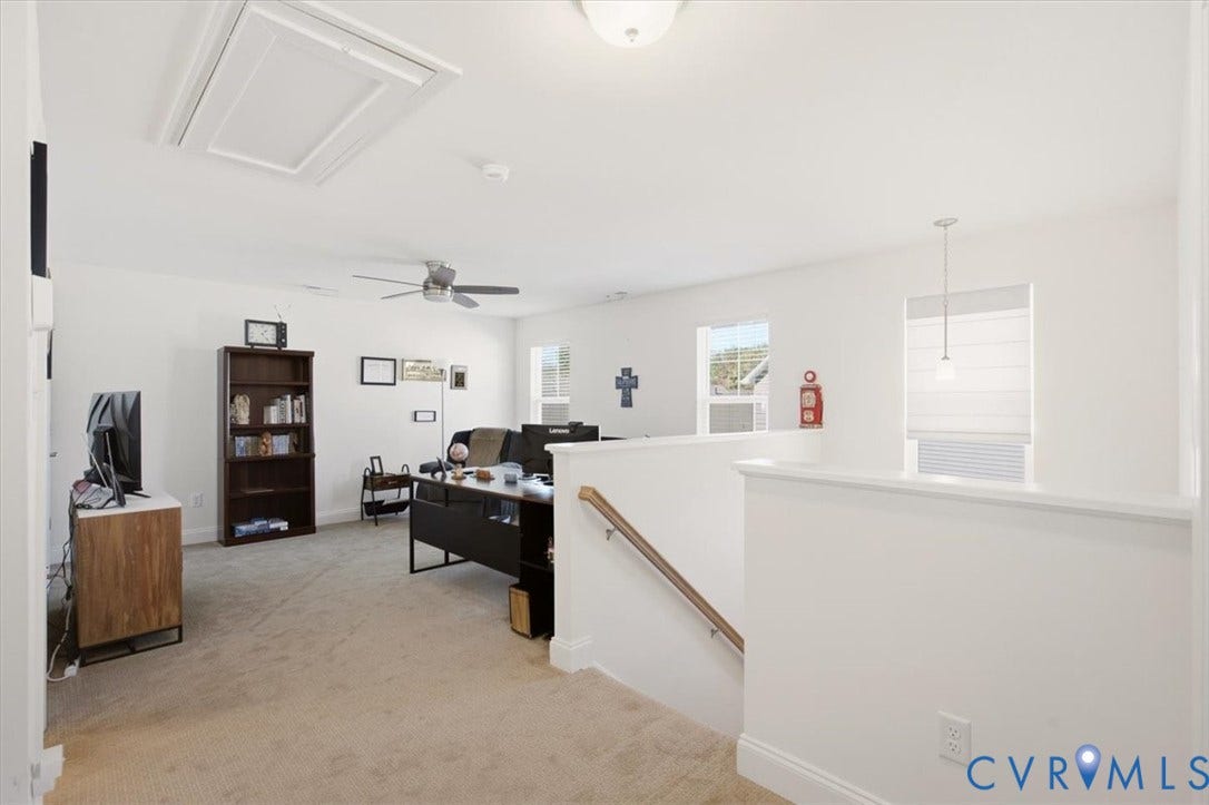18743 Palisades Ridge, Palisades Cove, Moseley, VA 23120 Open-concept space featuring neutral carpeting, a ceiling fan with integrated lighting, a flush-mount ceiling light, and a staircase with a handrail