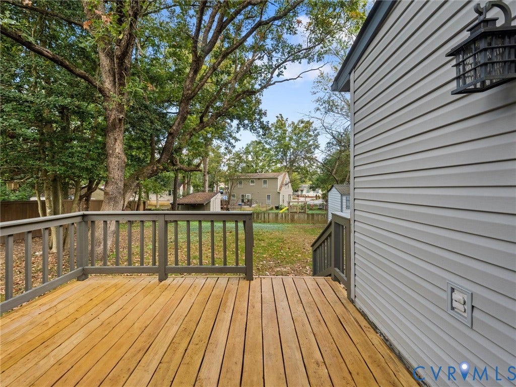 5504 Chanson Road, Salem Woods, North Chesterfield, VA 23237 Wood-plank deck featuring dark-toned railings, horizontal vinyl siding, and an attached exterior wall-mounted lantern