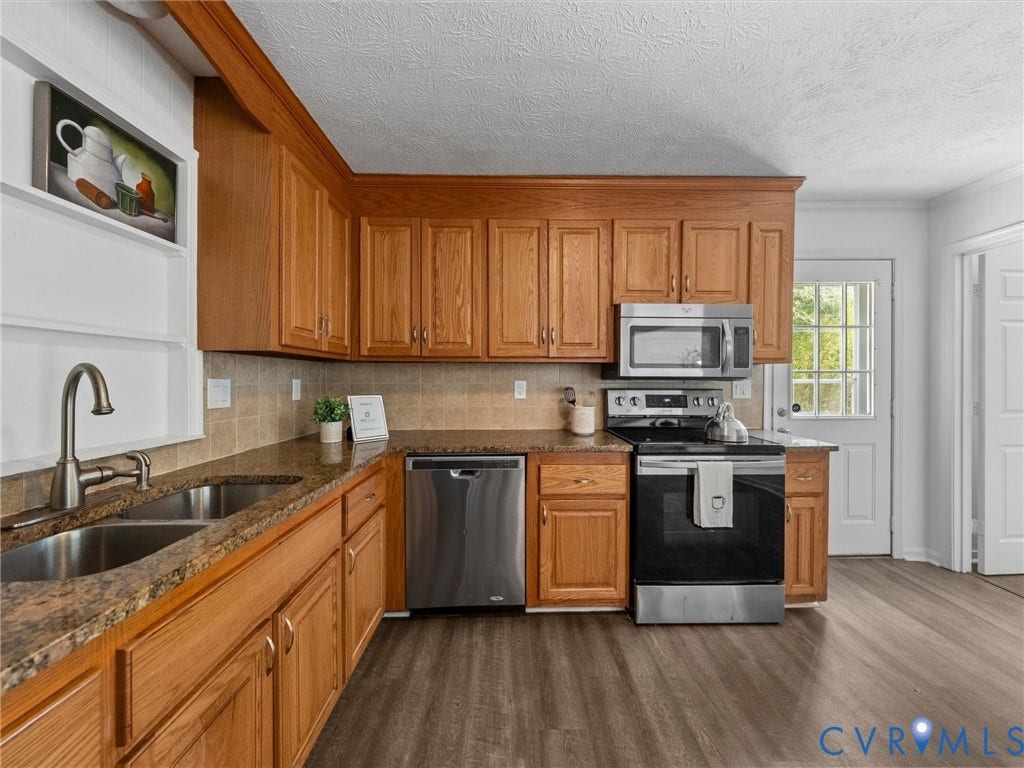 5504 Chanson Road, Salem Woods, North Chesterfield, VA 23237 Kitchen featuring wood cabinetry, stone-finish countertops, stainless steel appliances, and wood-finish flooring