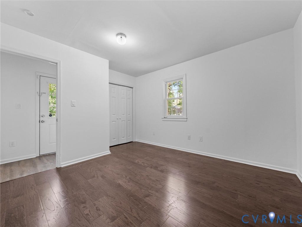 5504 Chanson Road, Salem Woods, North Chesterfield, VA 23237 Interior room featuring wood-finish flooring, a single window with white trim, and a built-in closet with bi-fold doors