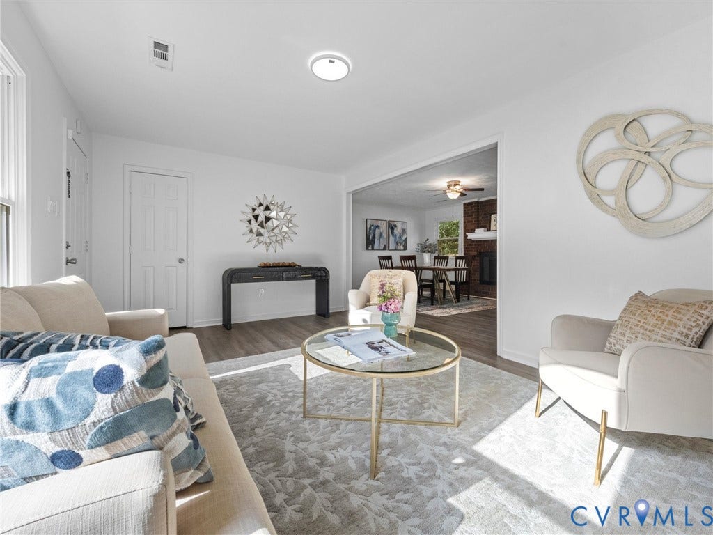 5504 Chanson Road, Salem Woods, North Chesterfield, VA 23237 Neutral interior featuring wood-finish flooring, white walls, and a recessed brick fireplace surround
