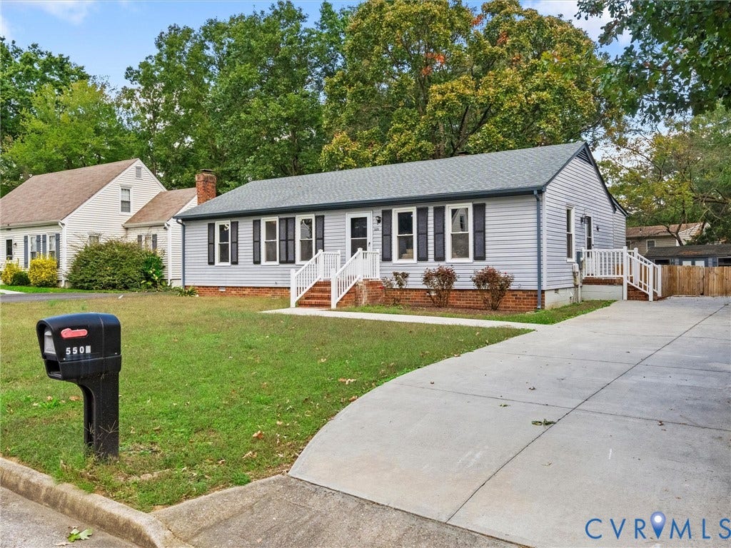 5504 Chanson Road, Salem Woods, North Chesterfield, VA 23237 Single-story exterior featuring light-gray horizontal siding, dark shutters, a brick foundation, white railings, and a concrete driveway