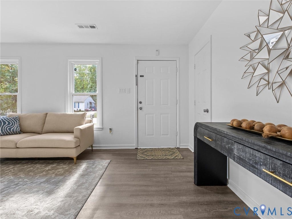 5504 Chanson Road, Salem Woods, North Chesterfield, VA 23237 Neutral interior space featuring wood-finish flooring, white walls, and multiple double-hung windows
