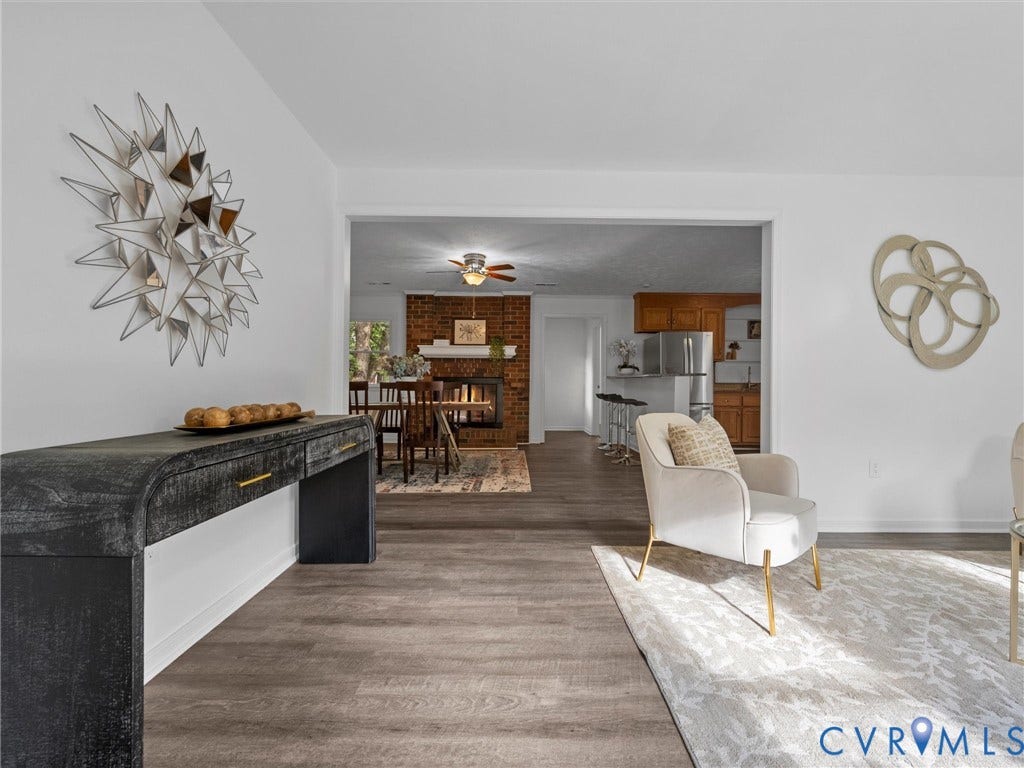 5504 Chanson Road, Salem Woods, North Chesterfield, VA 23237 Wood-finish flooring throughout, brick fireplace with a white mantel, and ceiling fan with integrated lighting