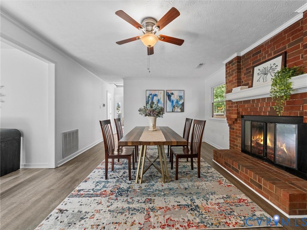 5504 Chanson Road, Salem Woods, North Chesterfield, VA 23237 Dining area featuring red brick fireplace, white mantel, wood-finish flooring, and ceiling fan with integrated lighting