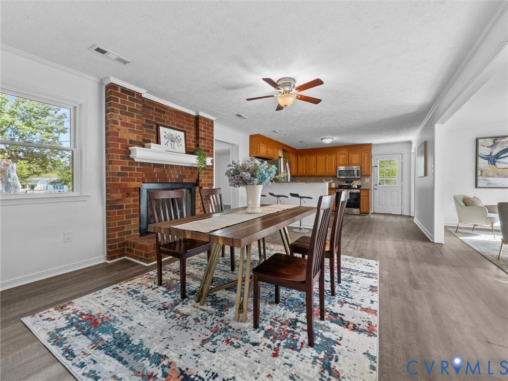 5504 Chanson Road, Salem Woods, North Chesterfield, VA 23237 Exposed brick fireplace with a decorative mantel, wood-finish flooring, and recessed ceiling lighting