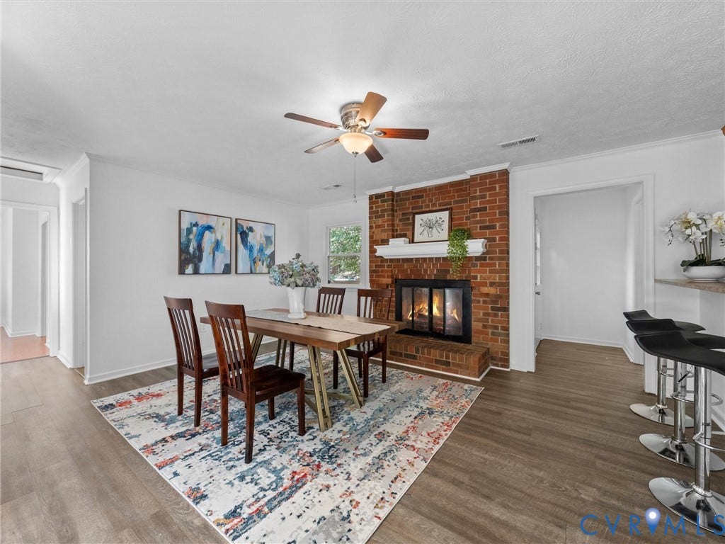 5504 Chanson Road, Salem Woods, North Chesterfield, VA 23237 Red brick fireplace with a decorative mantel, wood-finish flooring, and a ceiling-mounted light fixture with a fan