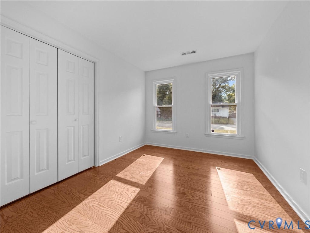 5504 Chanson Road, Salem Woods, North Chesterfield, VA 23237 Wood-finish flooring, dual windows with white casing, and floor-to-ceiling bi-fold closet doors