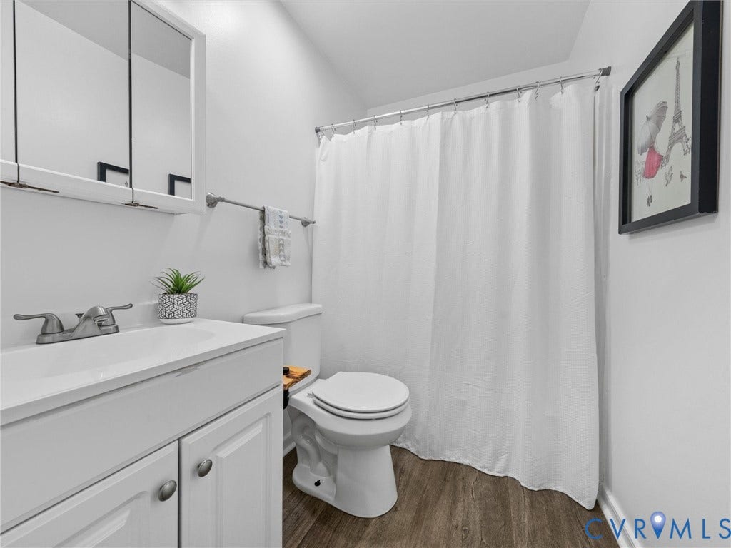 5504 Chanson Road, Salem Woods, North Chesterfield, VA 23237 Bathroom featuring wood-finish flooring, a white vanity cabinet with an integrated sink, polished metal faucet, and a wall-mounted mirrored medicine cabinet
